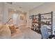 Inviting living room with a cozy couch and a decorative shelving unit for storage at 16911 W Palm Ln, Goodyear, AZ 85395