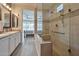 Luxurious bathroom boasting a glass-enclosed shower with built-in seating and dual vanity at 16911 W Palm Ln, Goodyear, AZ 85395