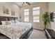 Relaxing main bedroom with large windows for natural light and a stylish accent wall at 16911 W Palm Ln, Goodyear, AZ 85395