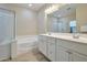 Primary bathroom with dual sinks, a soaking tub, and a shower at 16955 W Cypress St, Goodyear, AZ 85395