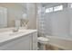 Well-lit bathroom features a tub and shower combination with a white vanity at 16955 W Cypress St, Goodyear, AZ 85395