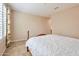 Bedroom features neutral walls, tile floor and window with plantation shutters at 16955 W Cypress St, Goodyear, AZ 85395