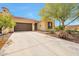 Charming single-story home featuring a desert-landscaped yard, a tile roof, and a two-car garage at 16955 W Cypress St, Goodyear, AZ 85395