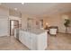 Open-concept kitchen with a large island, stainless steel appliances, and views of the living area at 16955 W Cypress St, Goodyear, AZ 85395