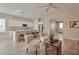 Open concept kitchen with white cabinets, granite countertops, stainless steel appliances, and a breakfast bar at 16955 W Cypress St, Goodyear, AZ 85395