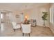 Bright living room with tile flooring, neutral decor, ceiling fan, and two white armchairs at 16955 W Cypress St, Goodyear, AZ 85395