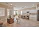 Open-concept living space with kitchen, breakfast bar, living room, neutral decor and tile flooring at 16955 W Cypress St, Goodyear, AZ 85395