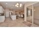 Open concept kitchen and living space with white cabinets, stainless appliances and a sliding door to the outside at 16955 W Cypress St, Goodyear, AZ 85395