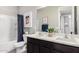 Bathroom featuring a double sink vanity with dark wood cabinets and matching framed artwork at 17160 N 9Th Pl, Phoenix, AZ 85022