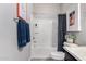 Comfortable bathroom with a shower featuring a stylish patterned curtain and matching blue hand towels at 17160 N 9Th Pl, Phoenix, AZ 85022
