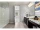 Bright bathroom featuring a glass enclosed shower and spacious vanity with double sinks and white countertops at 17160 N 9Th Pl, Phoenix, AZ 85022