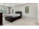Bedroom with neutral walls, carpet, and dark brown bed frame and dresser at 17160 N 9Th Pl, Phoenix, AZ 85022