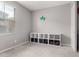 Well-lit bedroom with a decorative 'play' sign, white storage shelf, and large window with blinds at 17160 N 9Th Pl, Phoenix, AZ 85022