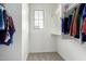 Well-lit walk-in closet features two rods for hanging clothes, plus carpeted floor at 17160 N 9Th Pl, Phoenix, AZ 85022