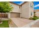 Side view of the property showcasing the two-car garage and brick-paved driveway at 17160 N 9Th Pl, Phoenix, AZ 85022
