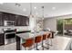 Updated kitchen with granite island and seating, stainless steel appliances, and dark cabinets at 17160 N 9Th Pl, Phoenix, AZ 85022
