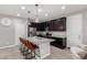 Modern kitchen with granite island, stainless steel appliances, and dark brown cabinets at 17160 N 9Th Pl, Phoenix, AZ 85022
