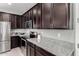 Kitchen features granite countertops, stainless steel appliances, and dark brown cabinetry at 17160 N 9Th Pl, Phoenix, AZ 85022