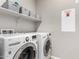 Bright laundry room with front loading washer and dryer and wire basket storage at 17160 N 9Th Pl, Phoenix, AZ 85022