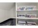 Organized pantry with white shelves and clear storage containers for food items at 17160 N 9Th Pl, Phoenix, AZ 85022