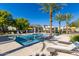 Community pool with lounge chairs, umbrellas, palm trees and landscaping, offering a resort-style experience at 17160 N 9Th Pl, Phoenix, AZ 85022