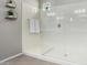 Modern glass shower with white tile surround and decorative wall plants at 17160 N 9Th Pl, Phoenix, AZ 85022