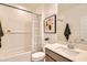 Well-lit bathroom featuring a shower-tub combination with clean fixtures and modern design at 17341 W Fallen Leaf Ln, Surprise, AZ 85387