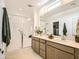 Modern bathroom with double vanity, glass-enclosed shower, and stylish fixtures at 17341 W Fallen Leaf Ln, Surprise, AZ 85387