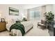 Serene bedroom with a plush bed, soft linens, and a charming accent chair at 17341 W Fallen Leaf Ln, Surprise, AZ 85387