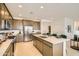 Modern kitchen featuring stainless steel appliances, spacious island with sink, and ample cabinetry at 17341 W Fallen Leaf Ln, Surprise, AZ 85387