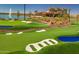 Lush putting green complete with sand traps, water features, and lush landscaping, perfect for recreation at 17341 W Fallen Leaf Ln, Surprise, AZ 85387