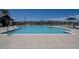 Inviting community pool with sun loungers, umbrellas, and clear blue water for residents' enjoyment at 17612 W Georgia Ave, Litchfield Park, AZ 85340
