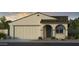 Charming single-story home featuring a two-car garage, arched entryway, and desert-friendly landscaping at 17612 W Georgia Ave, Litchfield Park, AZ 85340
