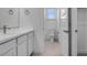 White bathroom with a sink, mirror, and toilet exudes a clean, minimalist design at 17827 W Medlock Dr, Litchfield Park, AZ 85340