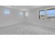 Spacious bedroom features plush carpeting and multiple windows, filling the room with natural light at 17827 W Medlock Dr, Litchfield Park, AZ 85340