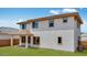 Side of the two-story home with windows, patio, and grass at 17827 W Medlock Dr, Litchfield Park, AZ 85340