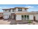 Stunning two-story home with a brick and stucco exterior, complemented by a well-manicured lawn and a driveway leading to a two car garage at 17827 W Medlock Dr, Litchfield Park, AZ 85340