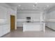 Bright, spacious kitchen with white cabinets, stainless steel appliances, a central island, and sleek countertops at 17827 W Medlock Dr, Litchfield Park, AZ 85340