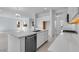 Open-concept kitchen with an island, stainless steel dishwasher, and seamlessly connecting to the living and dining areas at 17827 W Medlock Dr, Litchfield Park, AZ 85340