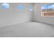 Bright bedroom with neutral carpeting and multiple windows for ample natural light at 17841 W Windsor Blvd, Litchfield Park, AZ 85340