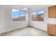 Bright dining area with large windows and neutral tile flooring for easy maintenance at 17841 W Windsor Blvd, Litchfield Park, AZ 85340