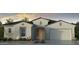 Charming single-story home with a neutral color palette, a two-car garage, and a tile roof at 17841 W Windsor Blvd, Litchfield Park, AZ 85340