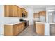 A bright and open kitchen with a stainless steel oven, microwave, and light wood cabinets at 17841 W Windsor Blvd, Litchfield Park, AZ 85340