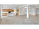 Spacious living area with tile flooring, light-filled spaces, and an open floor plan connecting to the kitchen at 17841 W Windsor Blvd, Litchfield Park, AZ 85340