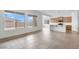 Expansive living space with tile floors, big windows, and a view of the modern kitchen at 17841 W Windsor Blvd, Litchfield Park, AZ 85340