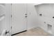 Clean mud room area with interior and exterior door access, tile floors and a utility sink at 17841 W Windsor Blvd, Litchfield Park, AZ 85340