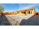 Spacious backyard featuring desert landscaping, block wall, and covered patio, perfect for outdoor relaxation at 18107 W Thunderhill Pl, Goodyear, AZ 85338