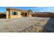 View of the large, dirt backyard from another angle showing the low block wall at 18107 W Thunderhill Pl, Goodyear, AZ 85338
