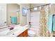 Bathroom featuring a shower-tub combo, a single sink vanity, and warm neutral paint at 18107 W Thunderhill Pl, Goodyear, AZ 85338