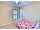Bedroom with a small bed, neutral walls, and a window with natural light at 18107 W Thunderhill Pl, Goodyear, AZ 85338